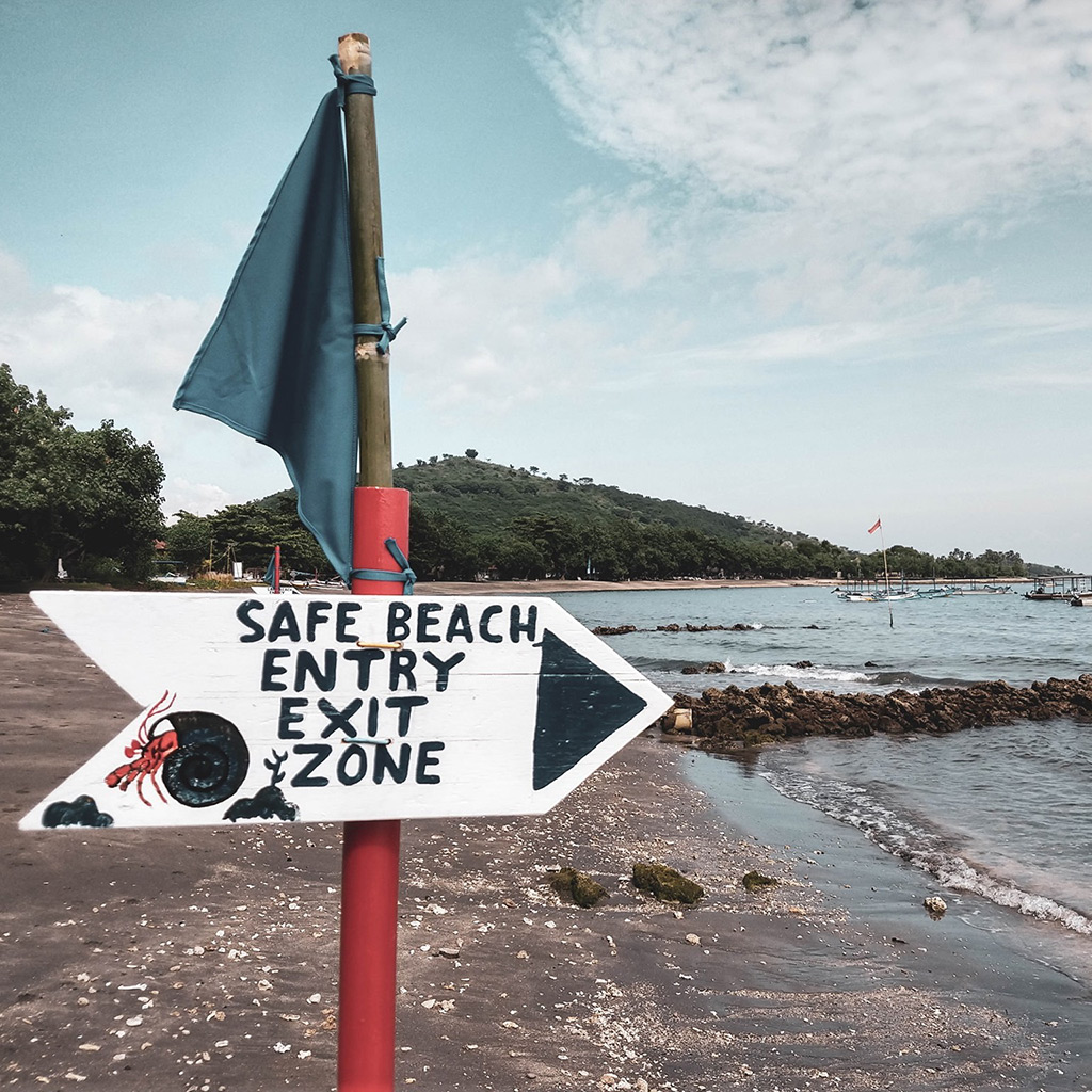 Signs for safe beach entry and exit zones in Pemuteran Bay